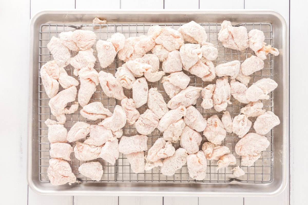 flour chicken on a wire rack