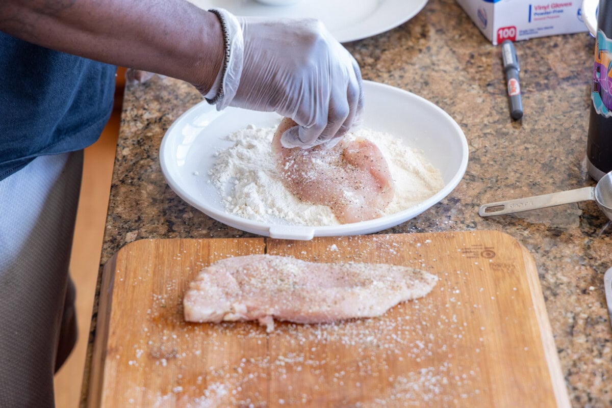 dredging chicken cutlets in flour