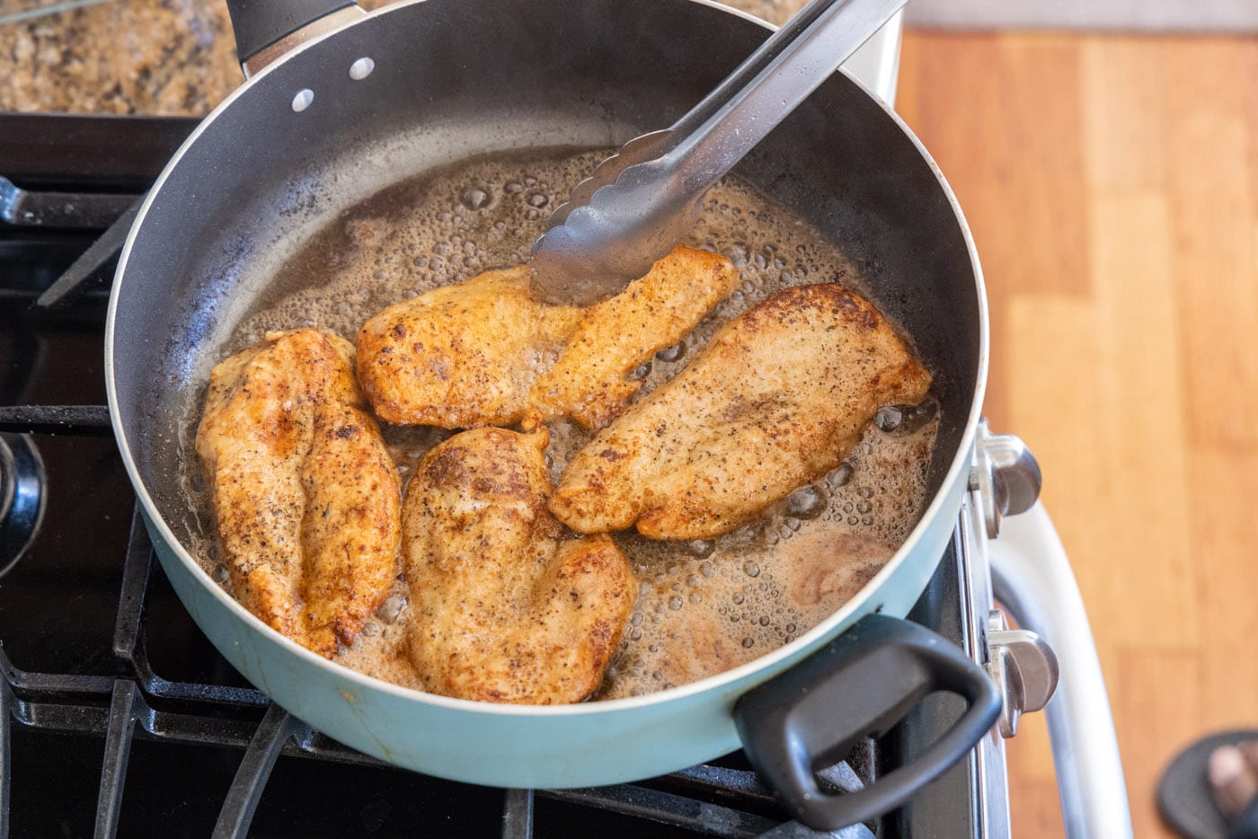 golden brown cooked chicken breasts in a skillet