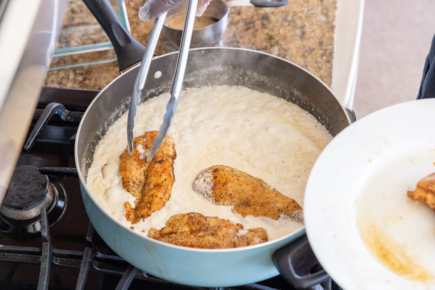 dredging chicken breasts in heavy cream mixture