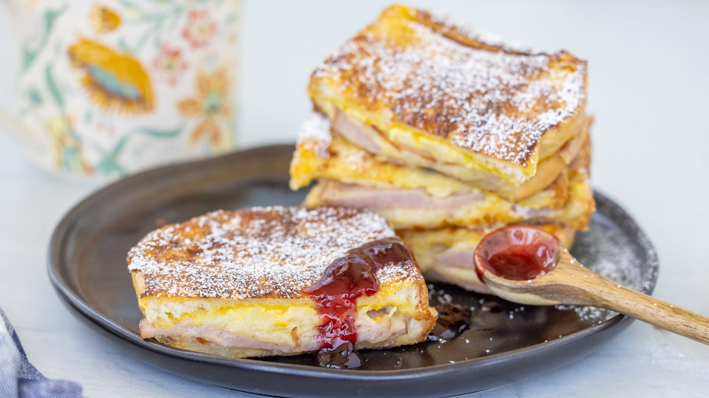 A Monte Cristo Sandwich is a flavor blast of cheese and salty ham sandwiched between two slices of h