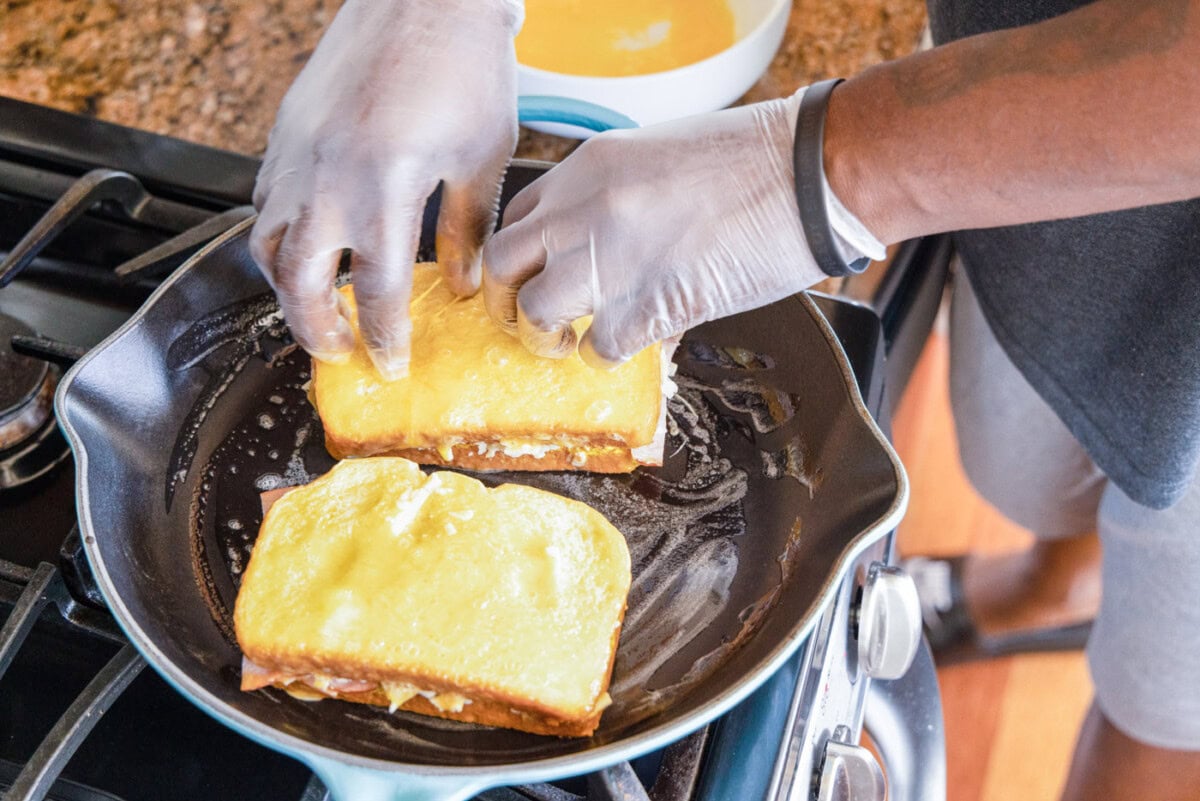 frying monte cristo sandwich in skillet with butter