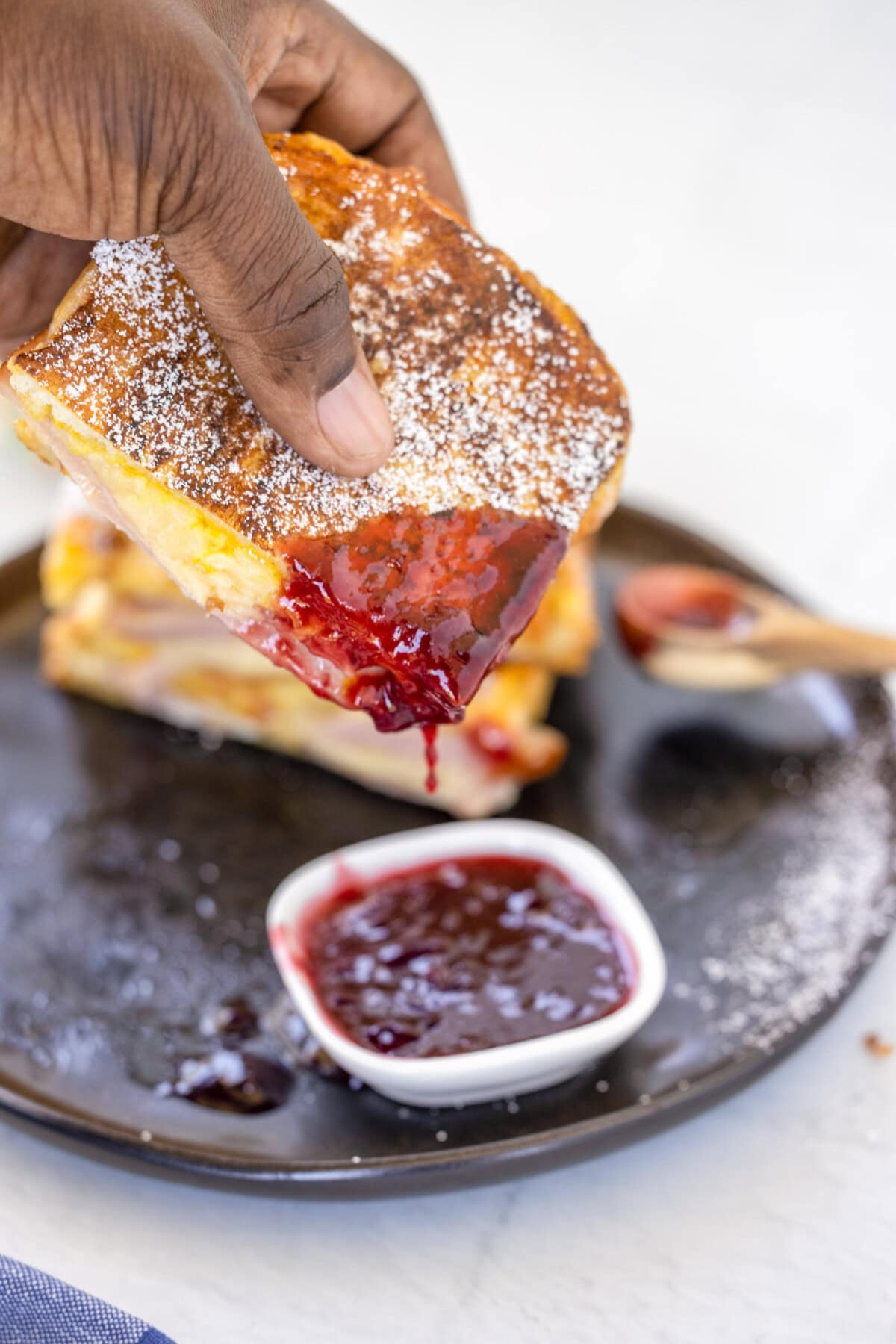 dipping a Monte Cristo Sandwich in jelly