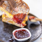 dipping a Monte Cristo Sandwich in jelly