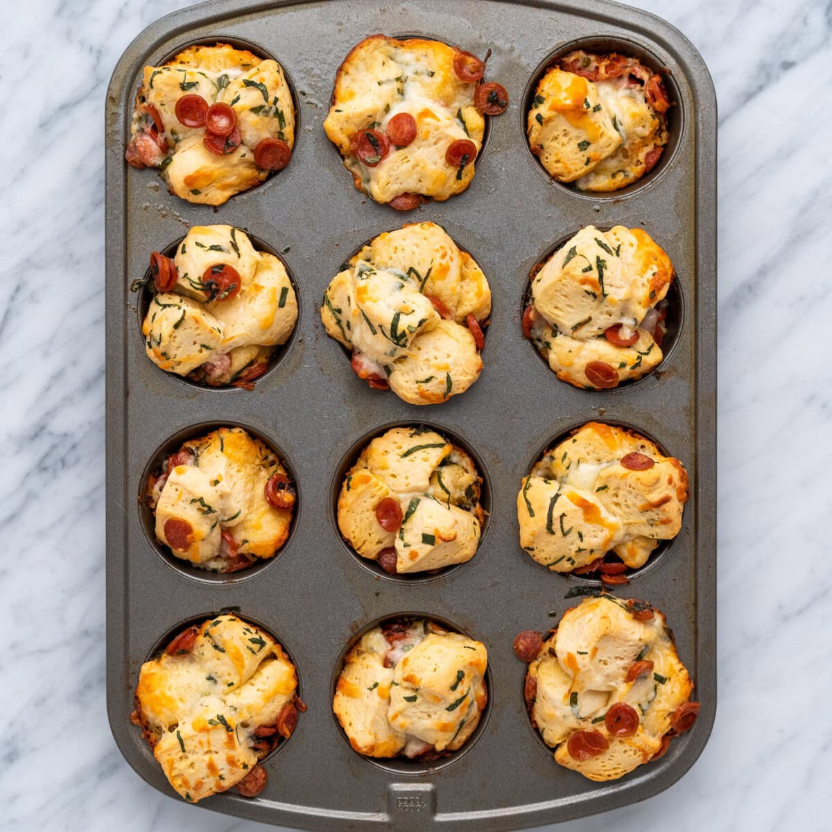 baked pizza bites in a muffin pan