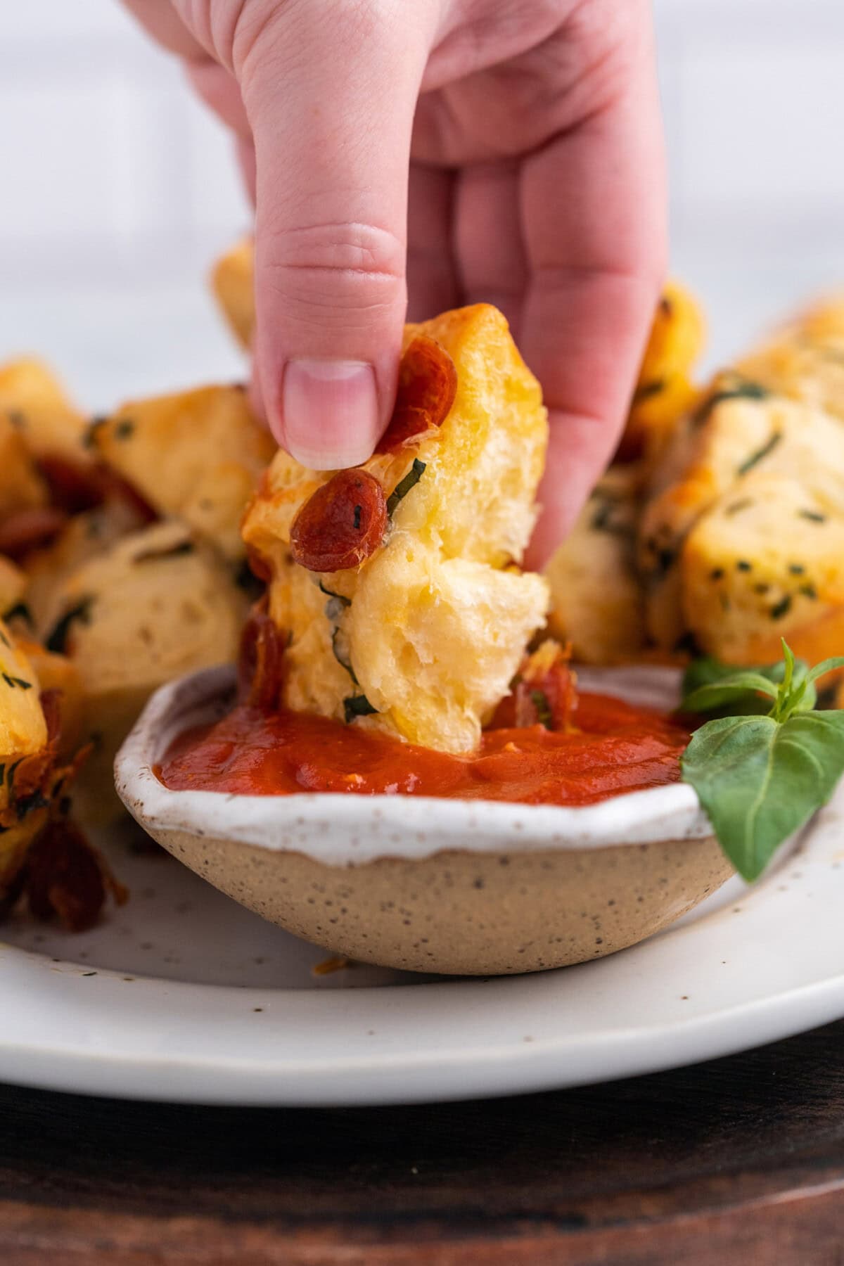 dipping a pizza bite in marinara