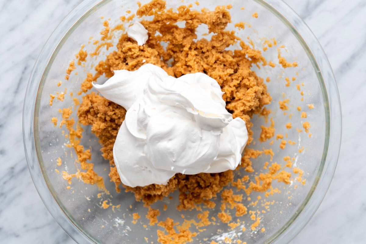 cool whip added to peanut butter mixture in a bowl