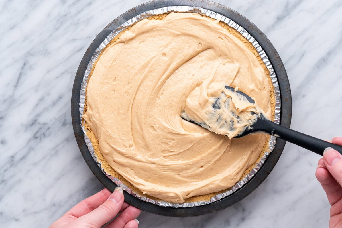 smoothing Reese's pie with a spatula