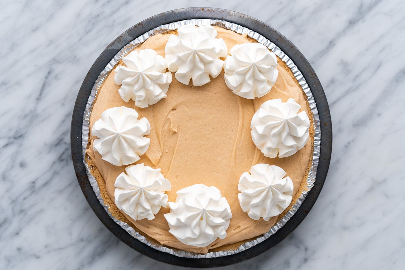 piped whipped cream rosettes on top of Reeses pie