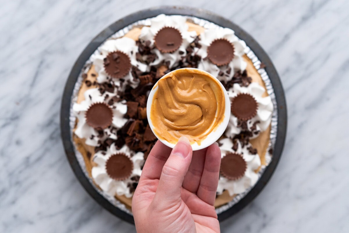 melted peanut butter held over the top of Reeses pie