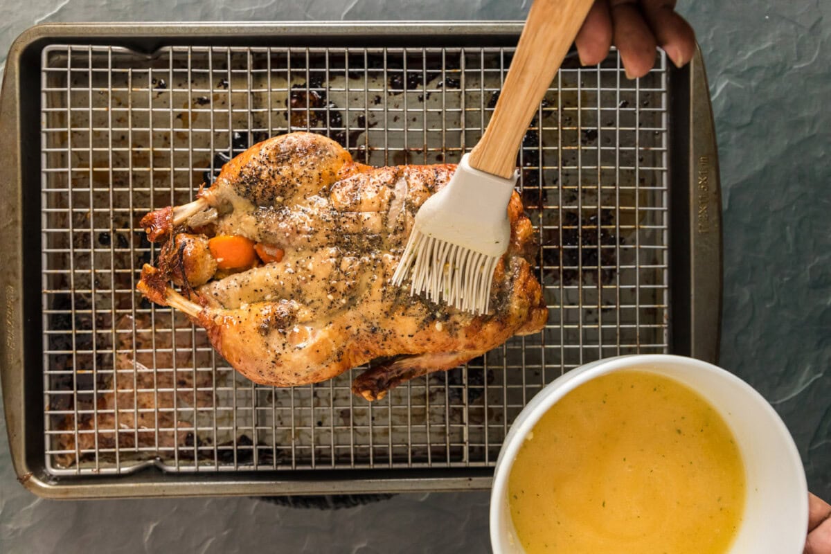 bating whole duck with mandarin juice and butter