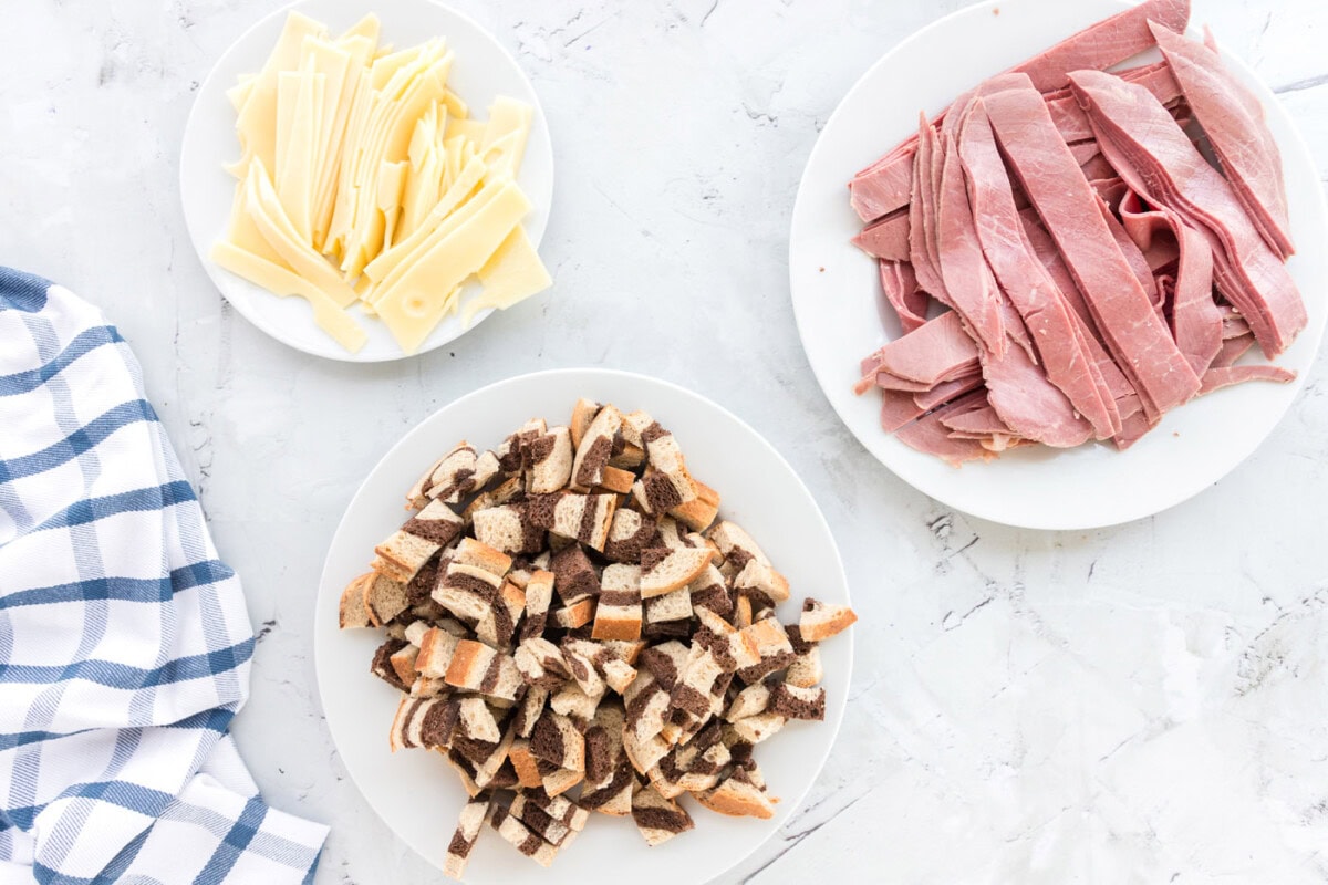 cubed rye bread, corned beef, and sliced swiss cheese