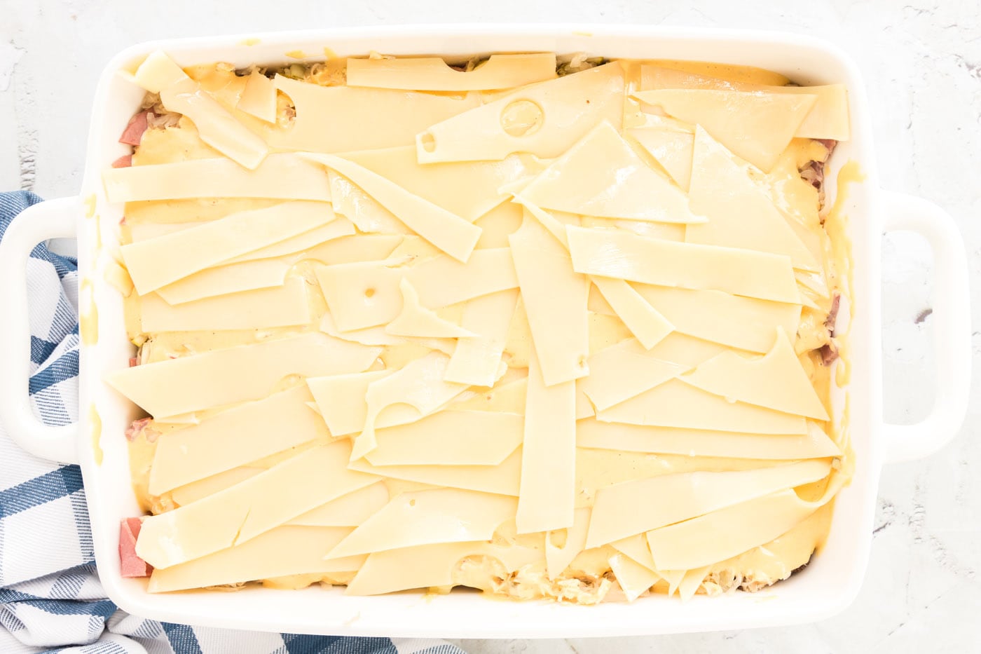 swiss cheese strips on top of thousand island dressing for reuben casserole