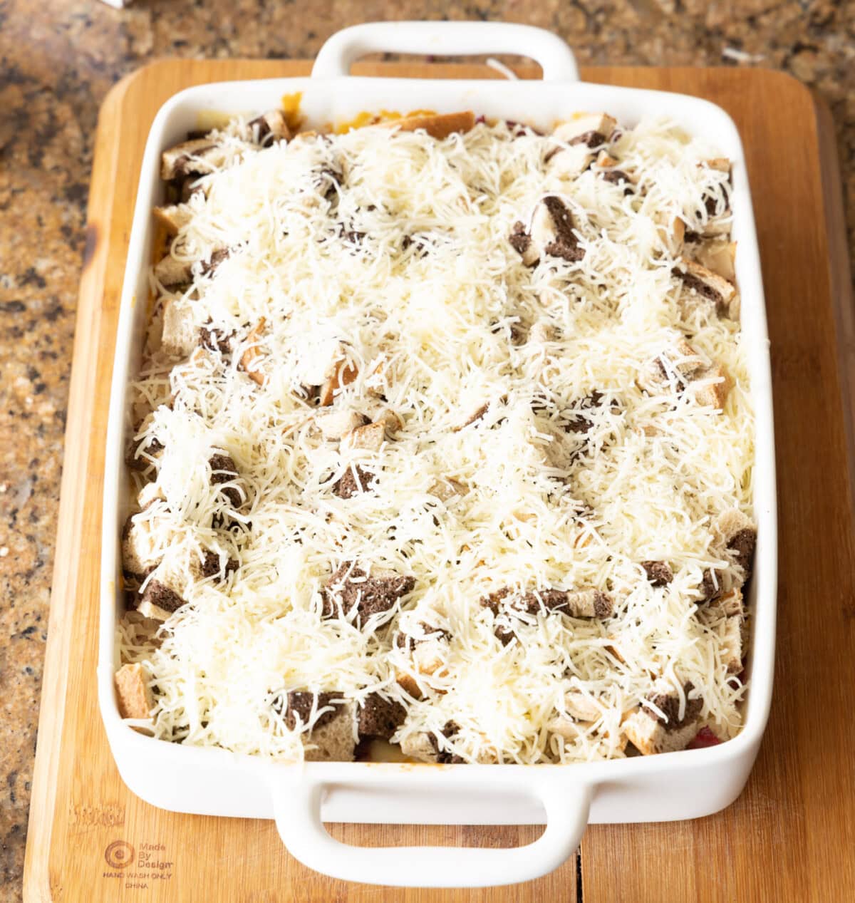 shredded Swiss cheese on top of reuben casserole