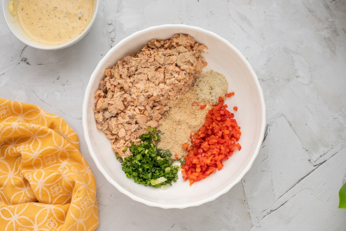 salmon, green onion, bell pepper, and bread crumbs in a bowl