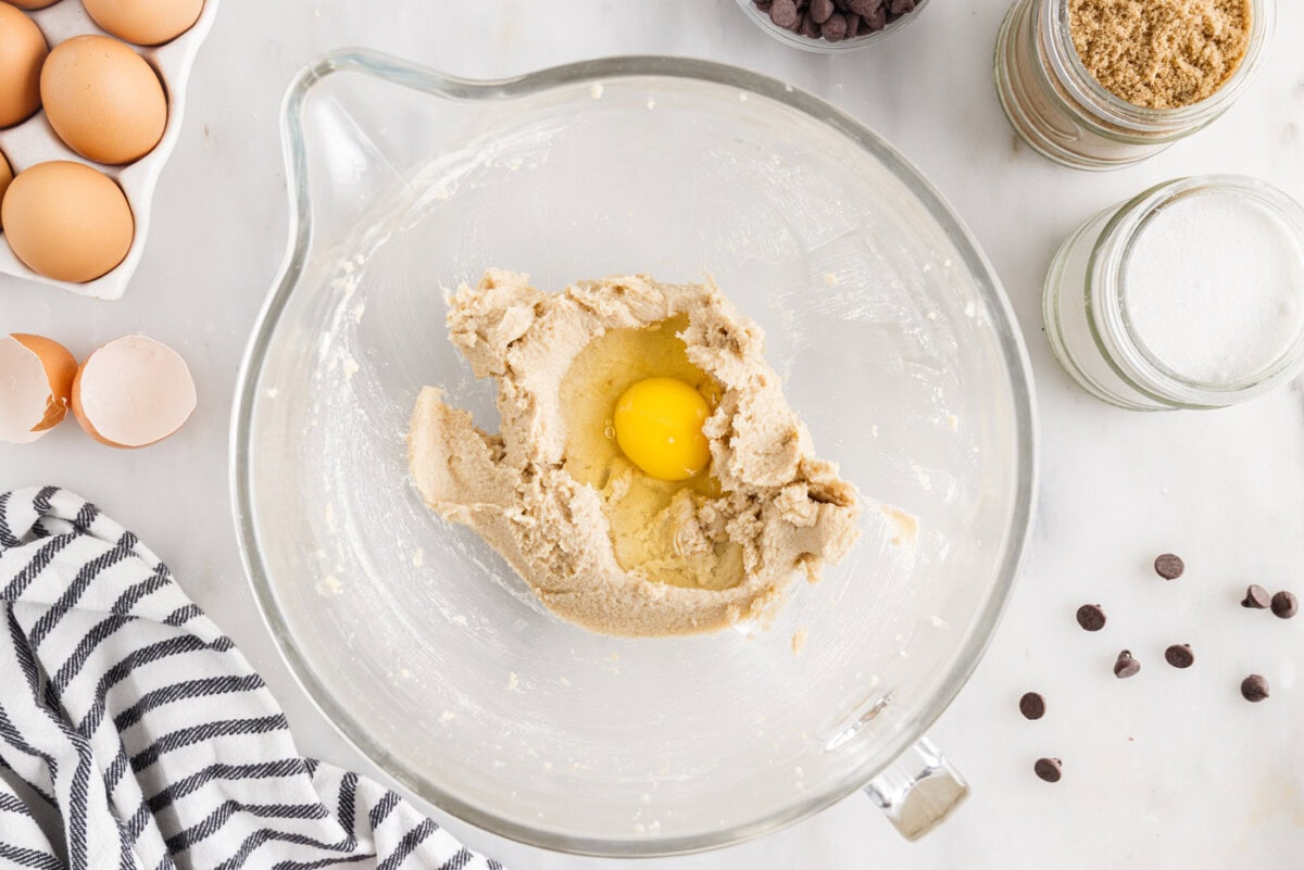 adding egg to cookie dough
