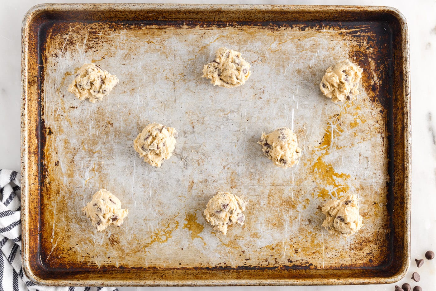 chocolate chip cookie dough balls on a baking sheet