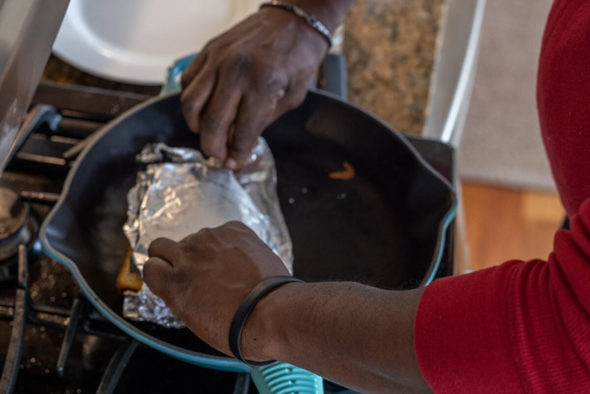flipping foil of tuna salad over bread in a skillet