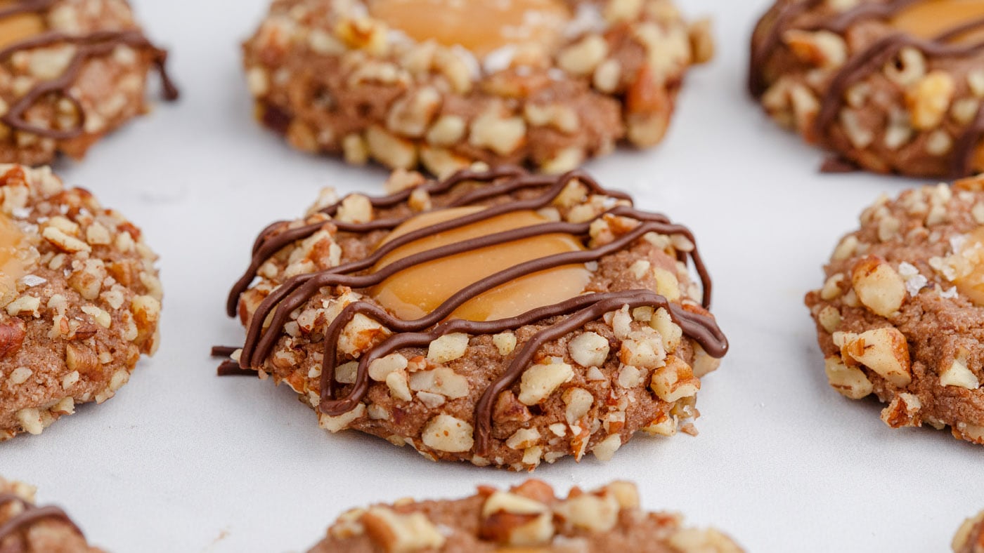 Turtle thumbprint cookies are brimming with different textures between the soft cookie base, the ric