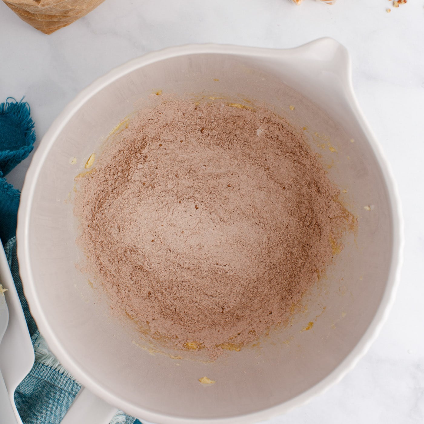 flour and cocoa powder added to mixer with butter and sugars
