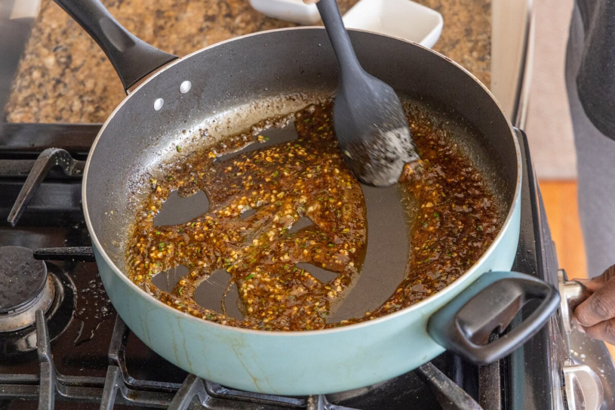 stirring pan juice with rosemary and lemon juice