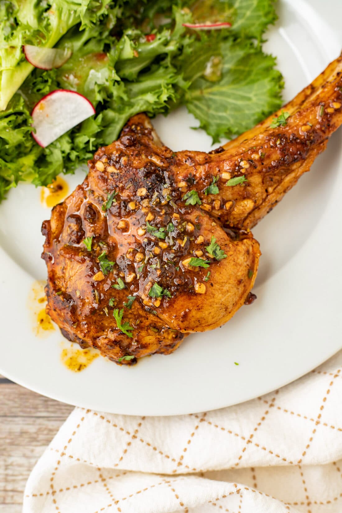 Veal Chop on a plate with salad