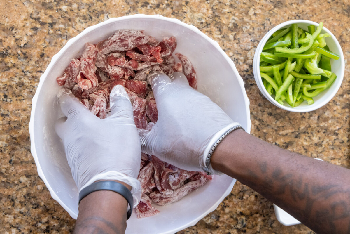 mixing sliced steak with cornstarch