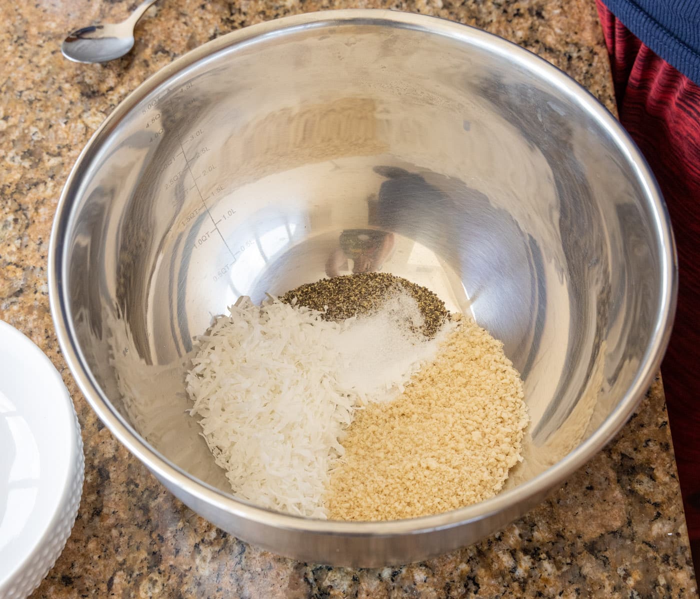 breadcrumbs, coconut flakes, and seasonings in a large mixing bowl