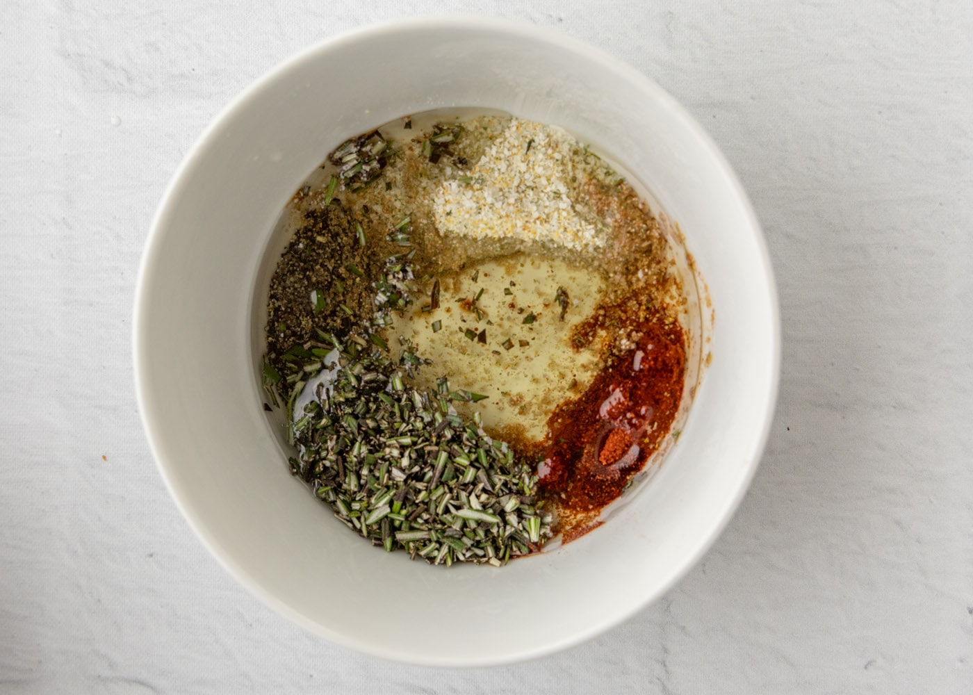 garlic salt, pepper, rosemary, paprika, liquid smoke, and olive oil in a medium bowl