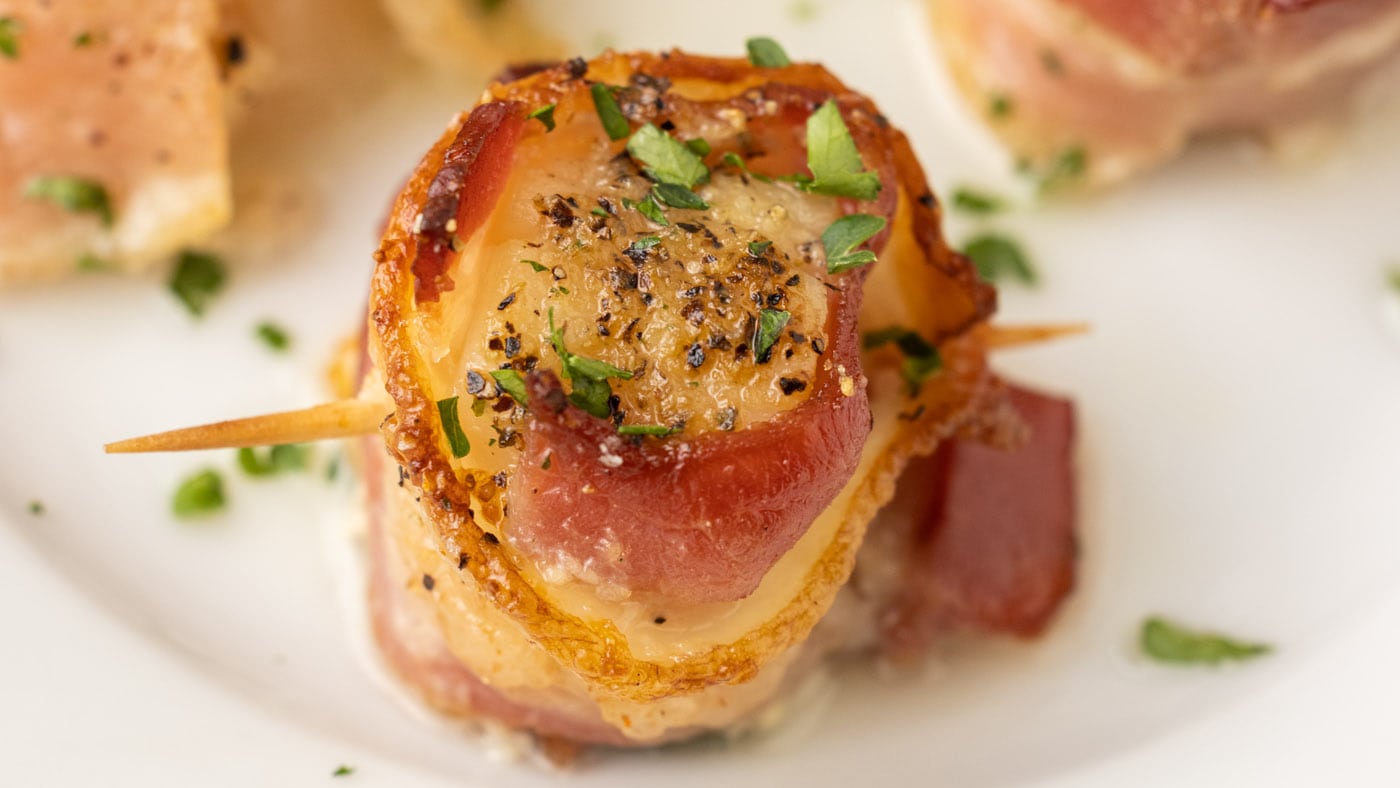Sea scallops are snuggled in a blanket of tender bacon for mini flavor-packed hors d'oeuvres. These 