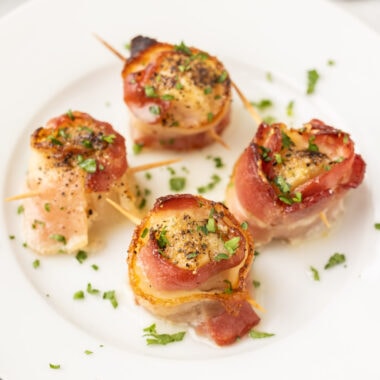 Bacon Wrapped Scallops on a white plate