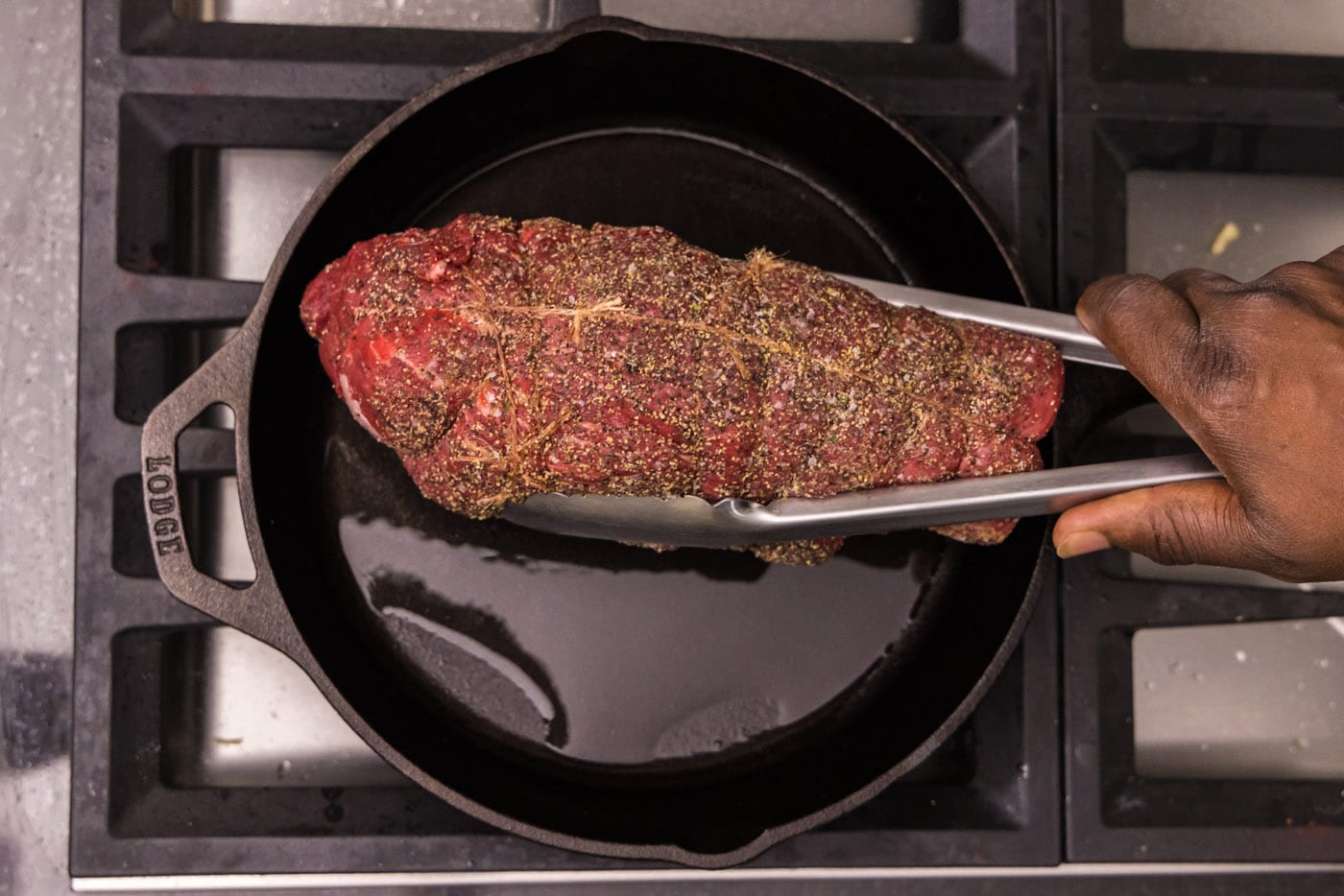 searing beef tenderloin in a skillet