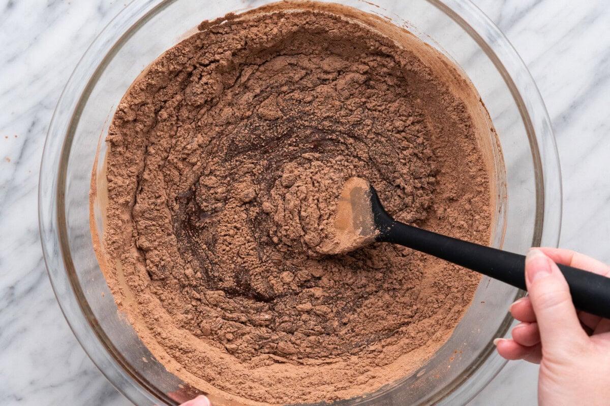folding in cocoa mixture into melted chocolate for brownie brittle