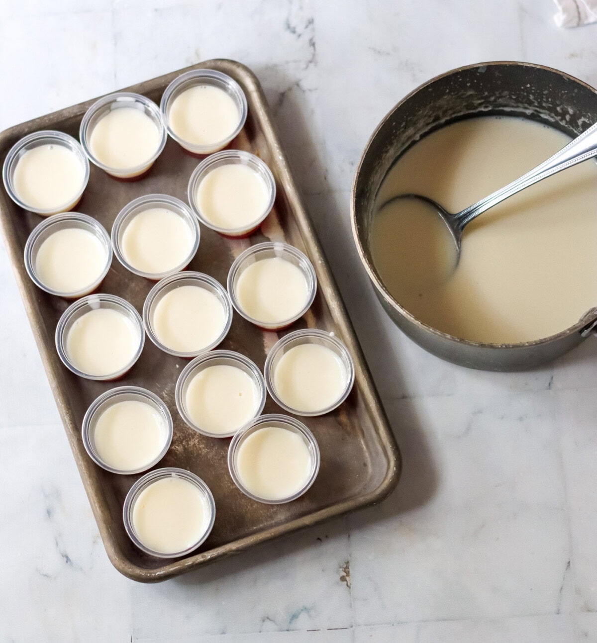 candy cane jello shots with sweetened condensed milk on a tray