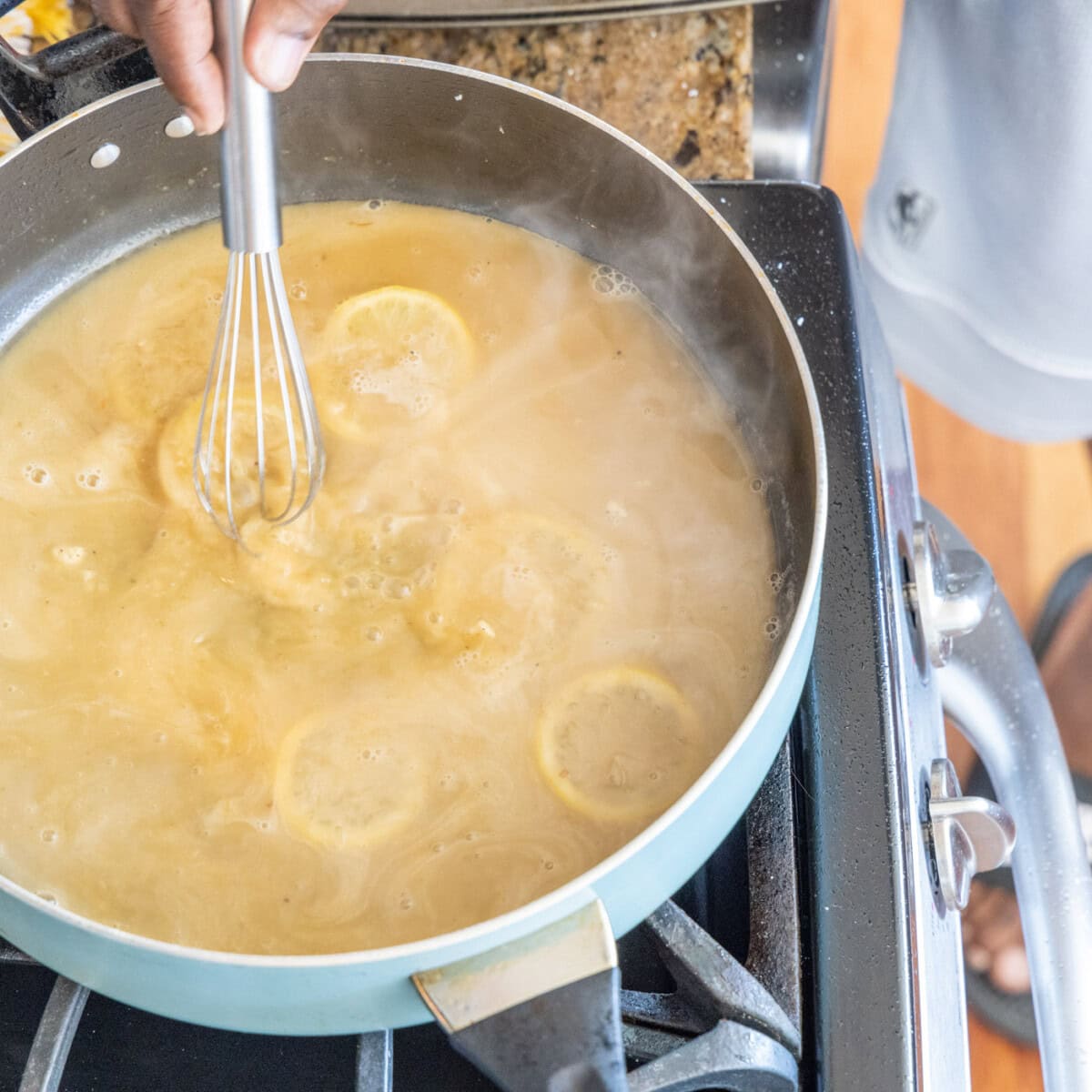 whisking butter and flour pan sauce with lemon