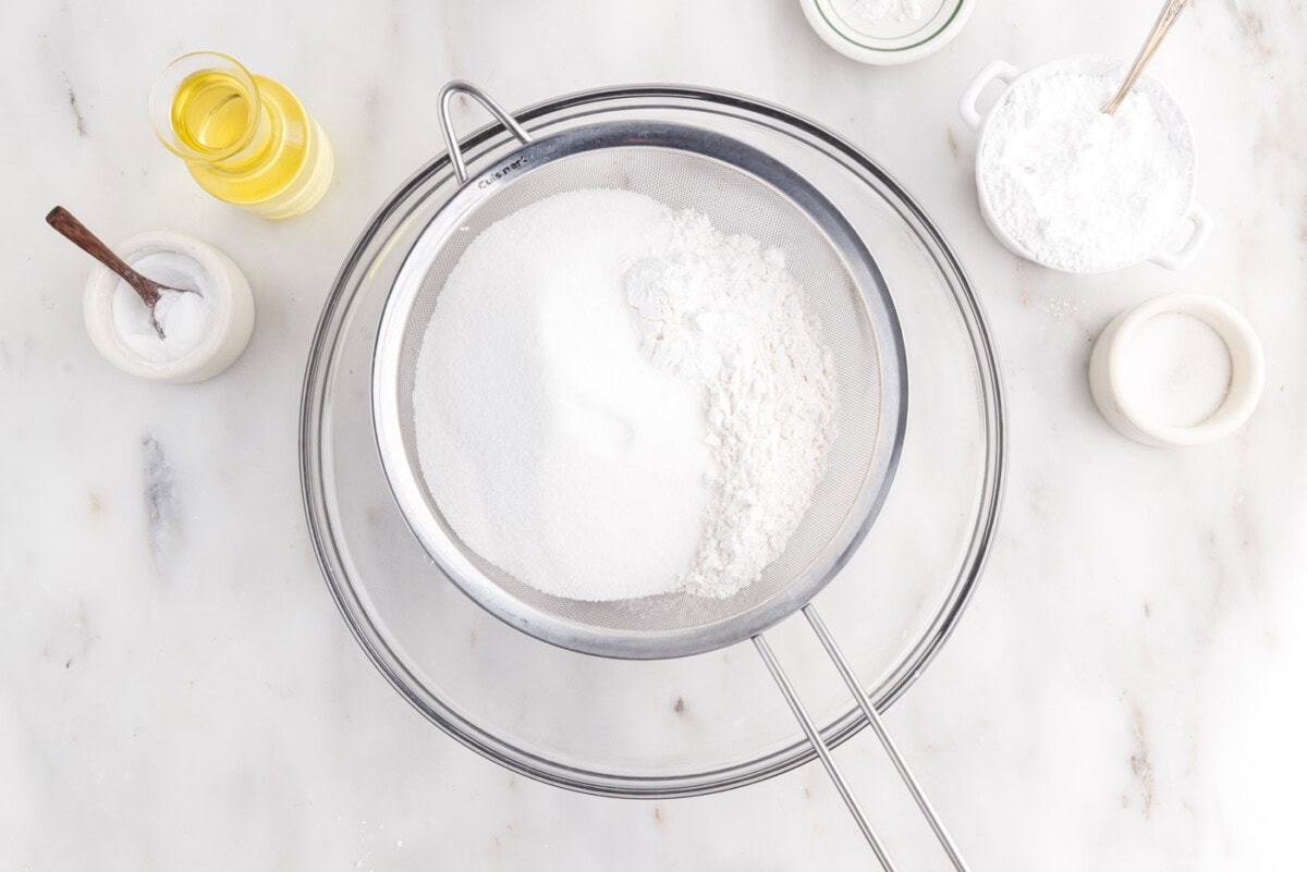 sifting cake flour, sugar, baking powder, and salt in a bowl