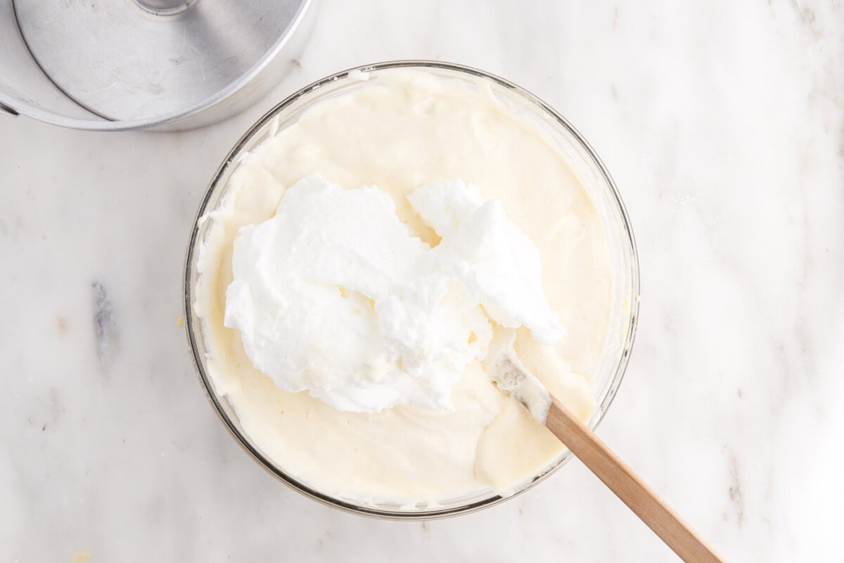 rubber spatula folding egg whites with egg yolks and flour