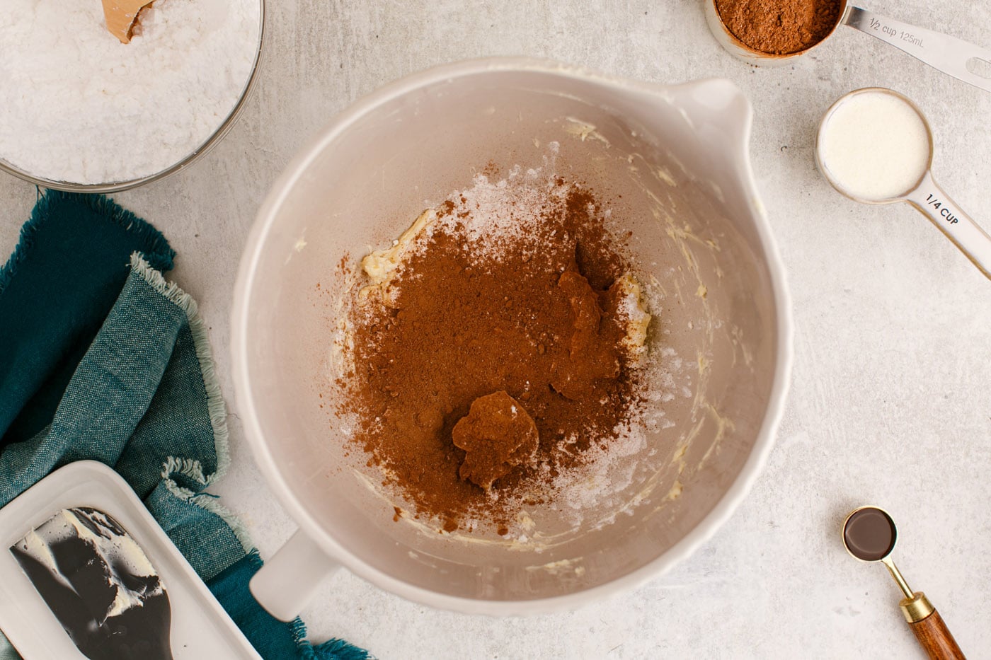 cocoa powder, powdered sugar, and butter in a mixing bowl