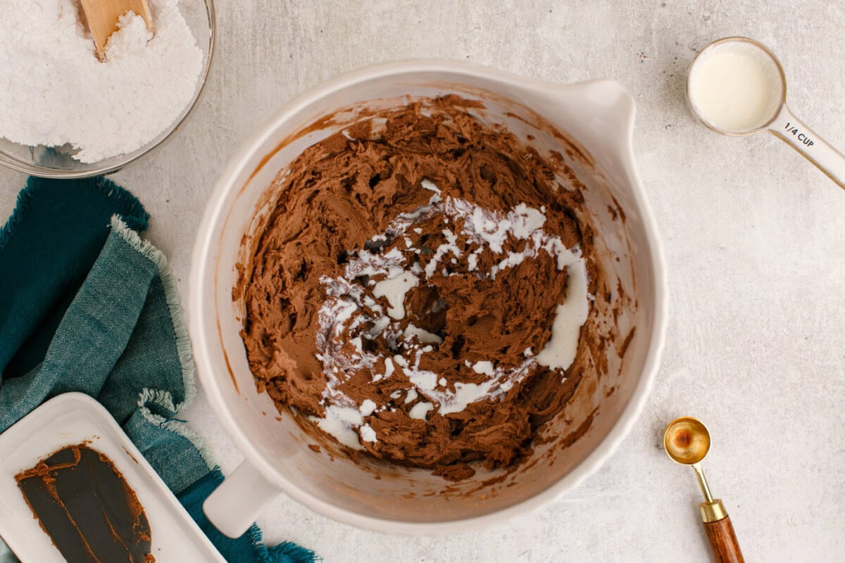 adding heavy cream to chocolate buttercream frosting