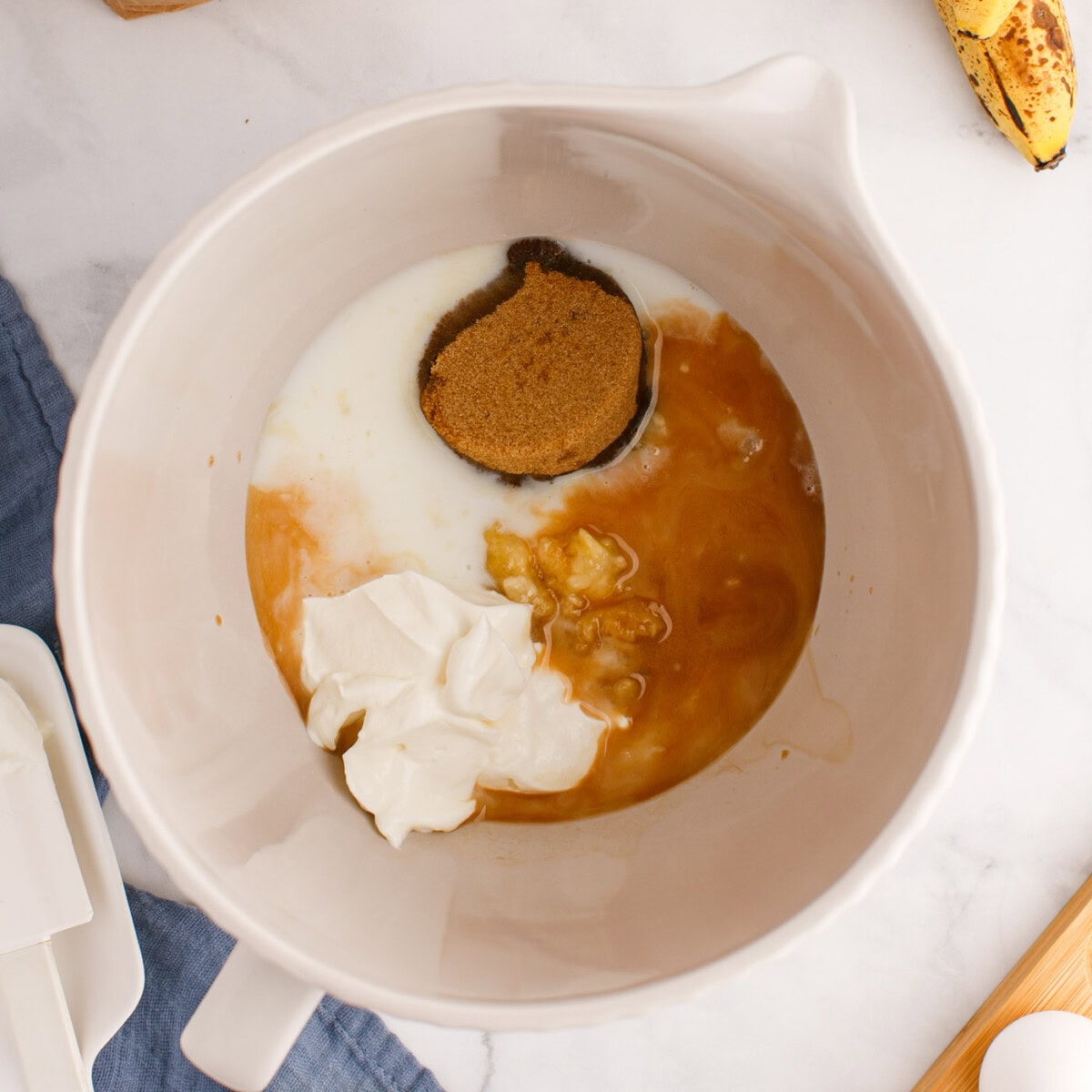 ingredients for chocolate chip banana muffins in a bowl