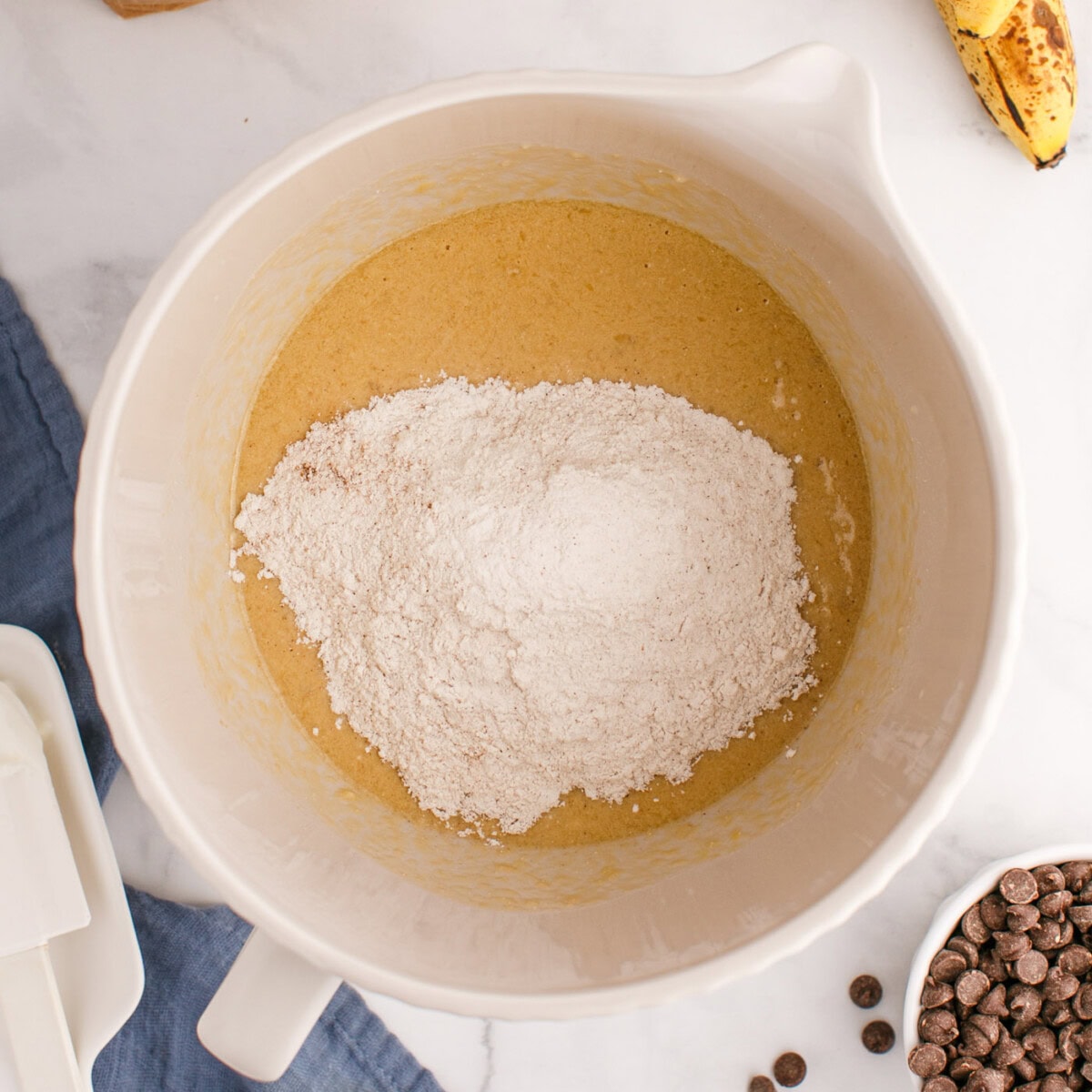 adding flour to muffin batter
