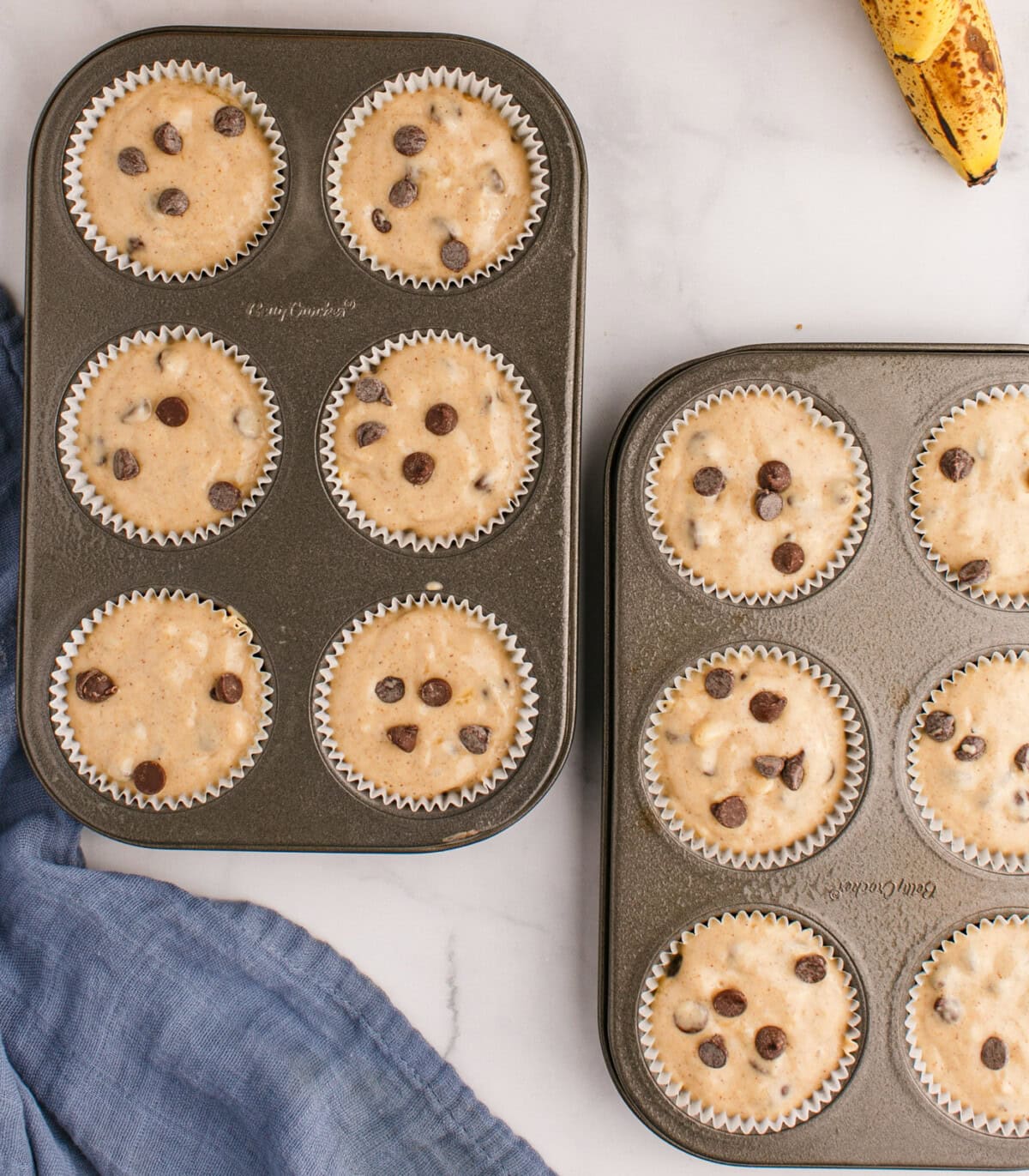 chocolate chip banana muffin batter in muffin trays