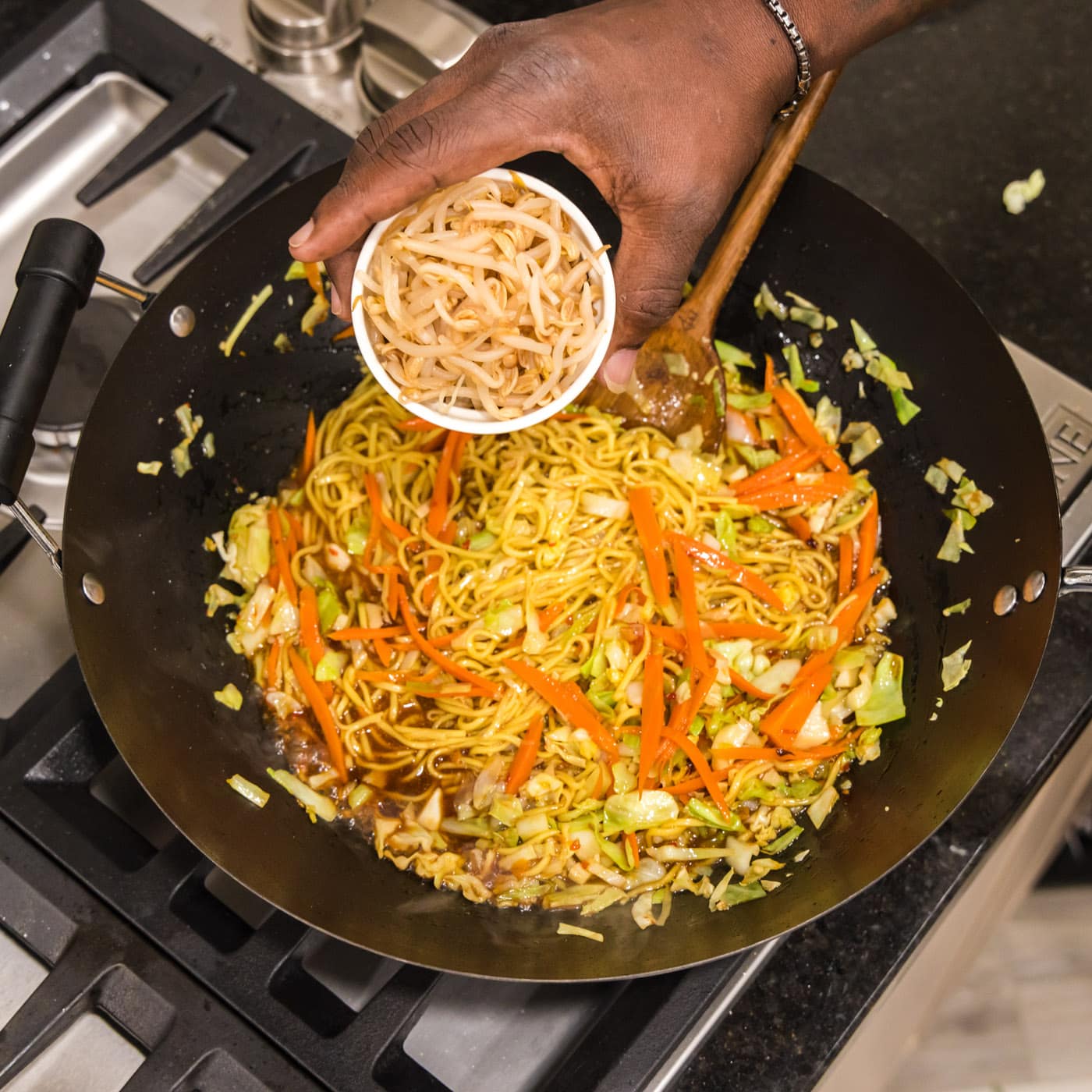 adding bean sprouts to chow mein
