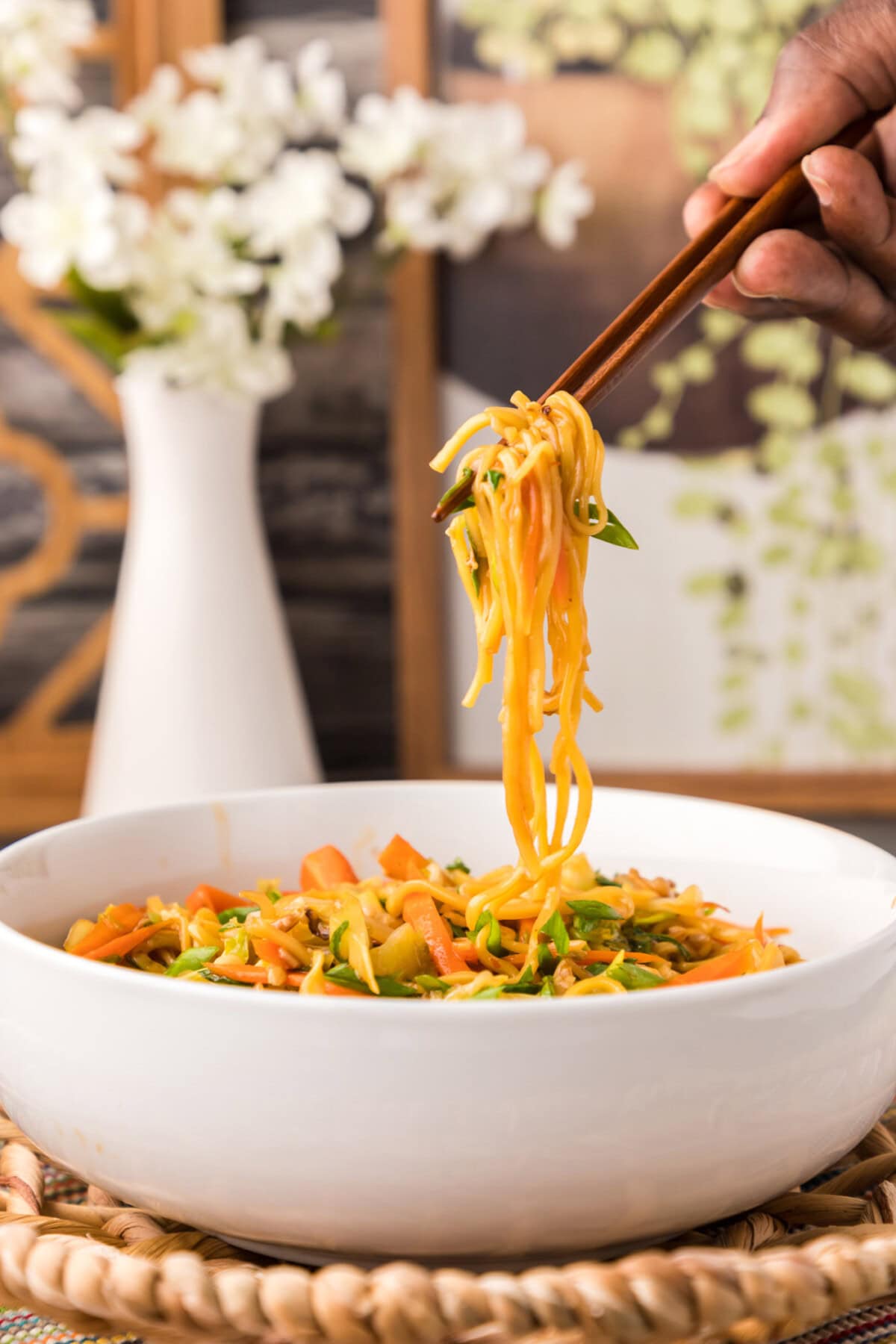 lifting Chow Mein with chopsticks