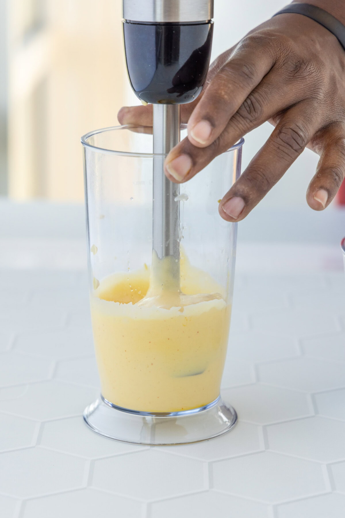 blending hollandaise sauce with an immersion blender