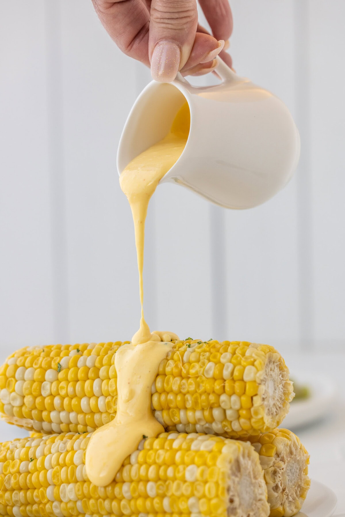 pouring Hollandaise Sauce on corn