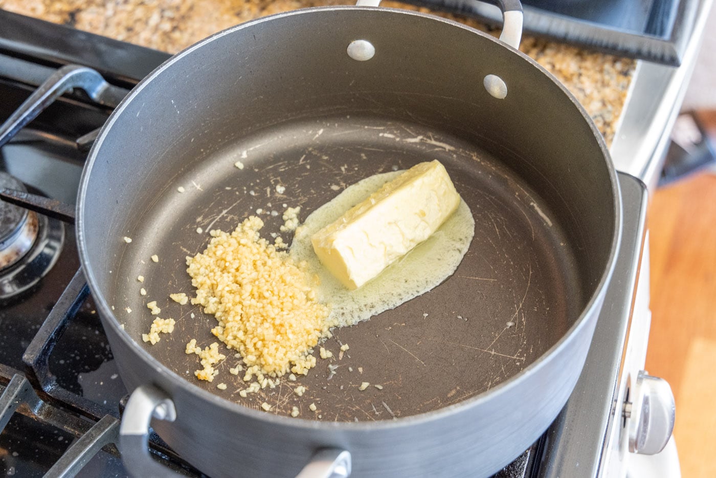 minced garlic with butter in a dutch oven