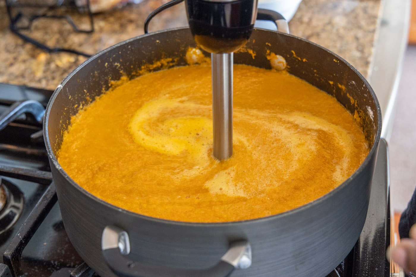blending heavy cream into lobster soup