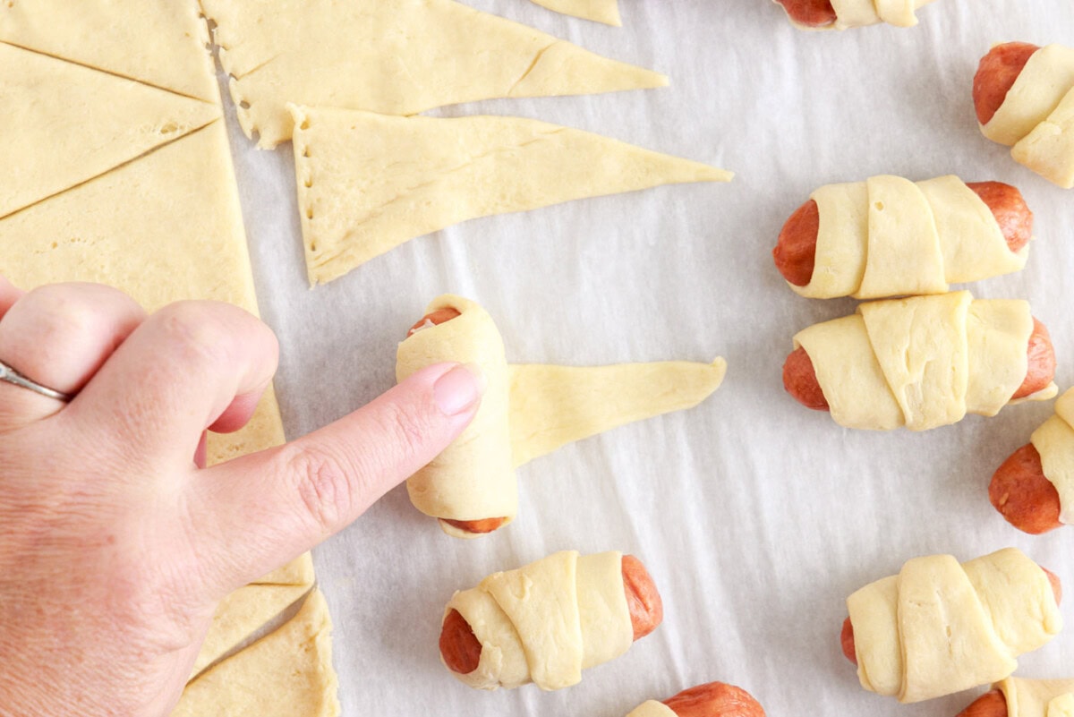 rolling mini dogs in crescent dough