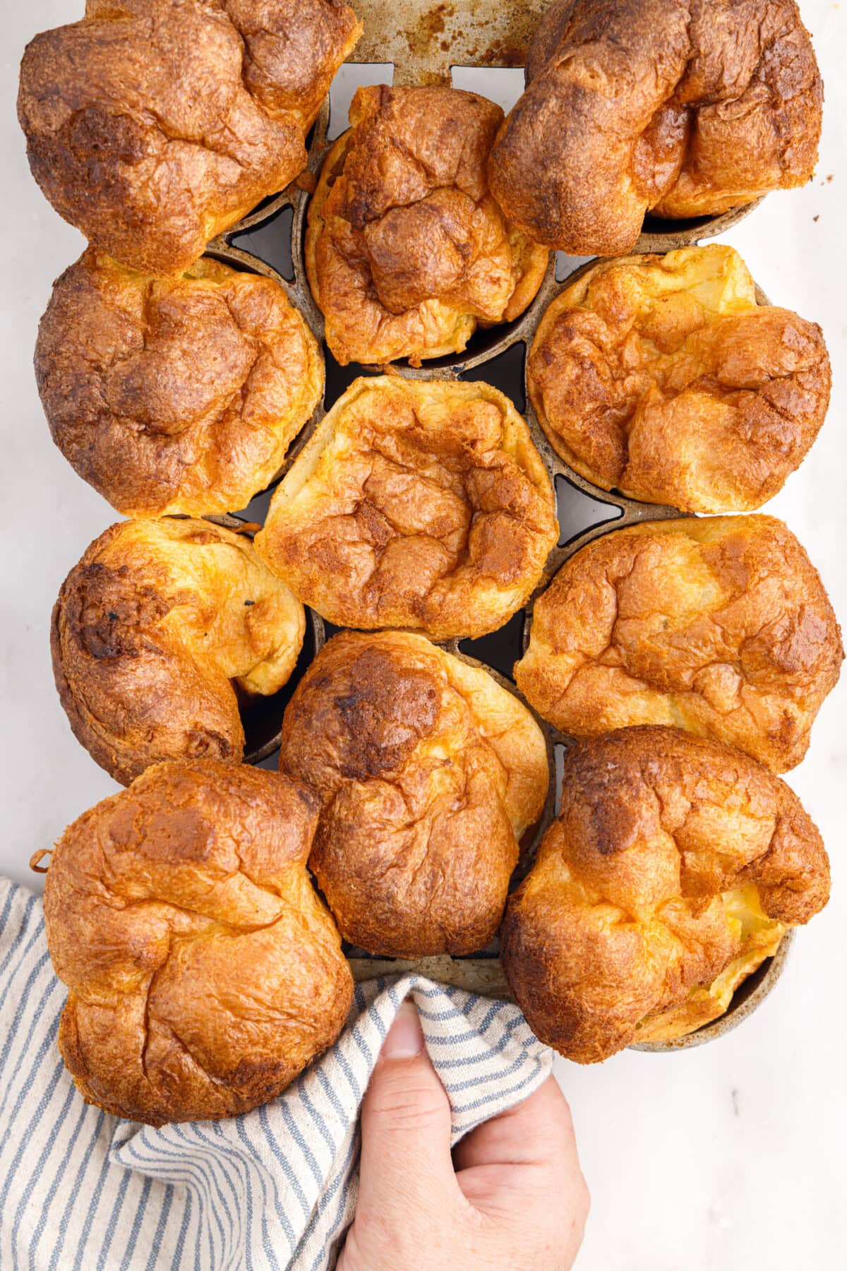 lifting a pan of Popovers